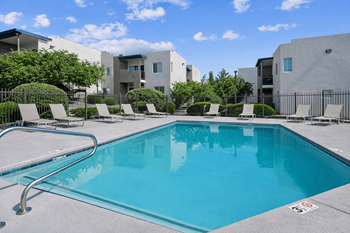 Resort style pool with lounge chairs and fencing